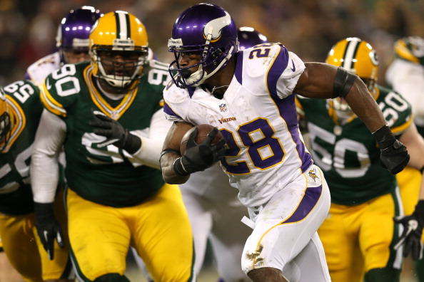 GREEN BAY, WI - JANUARY 05: Running back Adrian Peterson #28 of the Minnesota Vikings runs the ball in front of nose tackle B.J. Raji #90 of the Green Bay Packers in the second half during the NFC Wild Card Playoff game at Lambeau Field on January 5, 2013 in Green Bay, Wisconsin. (Photo by Jonathan Daniel/Getty Images)